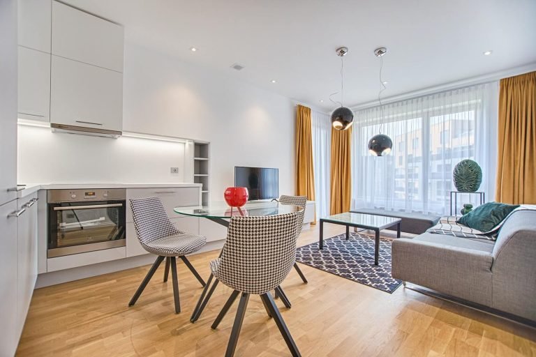 two chairs with glass table on living room near window.jpg